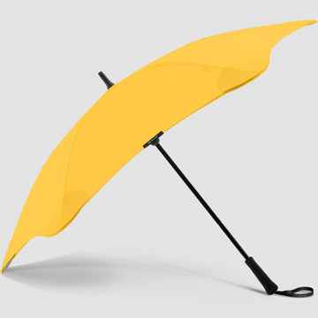 An open umbrella in yellow with a black handle.