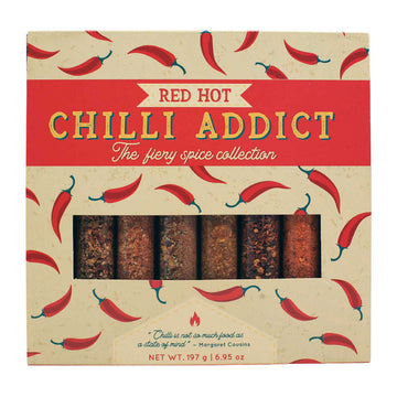 A box with the title 'Red Hot Chilli Addict The Fiery Spice Collection' with a background of illustrated peppers and a window showing the chilli flakes inside.