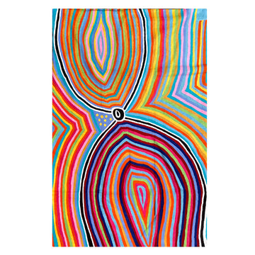 A wool rug is laid out flat and printed with artwork by Liddy Napanangka Walker in different colours.