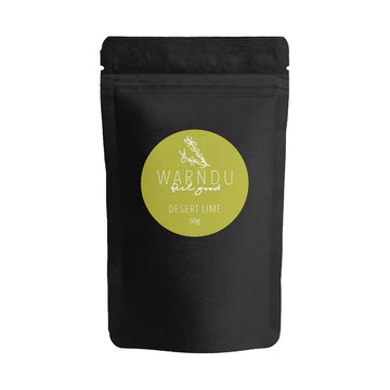 A black packet with a round green label with the text 'Warndu Feel Good Desert Lime'.