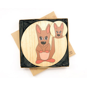 A set of a wooden round coaster and place mat inside a box. Both items are printed with an illustration of a kangaroo.