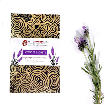 Lavender sachets printed with artwork by Nelly Patterson with a lavender sprig next to them.