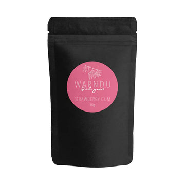 A black packet with a round pink label on the front with the text 'Warndu Feel Good Strawberry Gum'.
