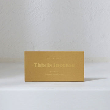 A rectangle box in mustard yellow with the text 'This is Incense' written in gold.