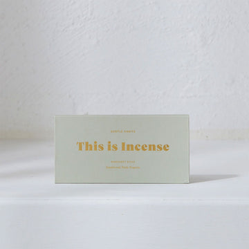 A rectangle box in sage green with the text 'This is Incense' written in gold on the front.