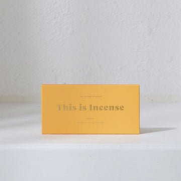 A yellow box with the text 'This is Incense' written in gold on the front.