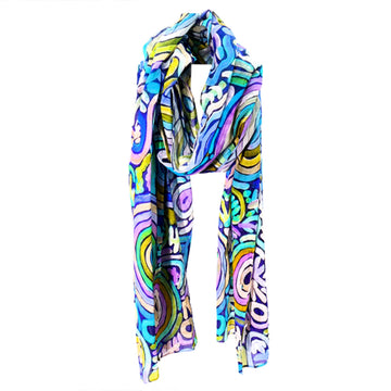 A cotton scarf is laid like it was wrapped around a neck. The scarf features artwork by Cedric Varcoe in blue, purple and yellow.