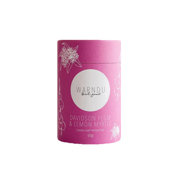 A pink canister with a white round label on the front with the text 'Warndu Feel Good Davidson Plum and Lemon Myrtle'.