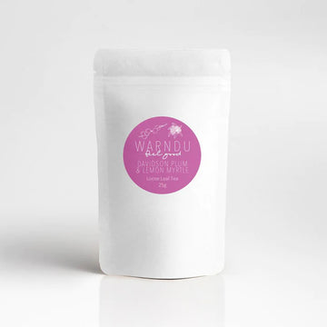 A white packet with a pink round label on the front with the text 'Warndu Feel Good Davidson Plum and Lemon Myrtle'.