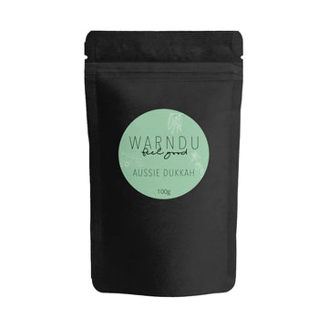 A black packet with a light green round label on the front with the text 'Warndu Feel Good Aussie Dukkah'.