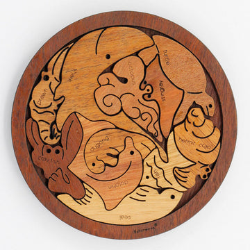 A round puzzle with different marine animals as each puzzle piece. The animals include a octopus, hermit crab and dolphin.