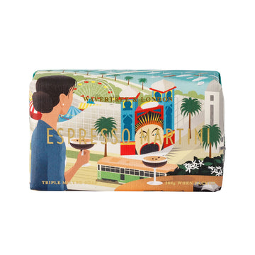 A bar of soap wrapped in packaging illustrated with a woman drinking a martini while overlooking Luna Park.