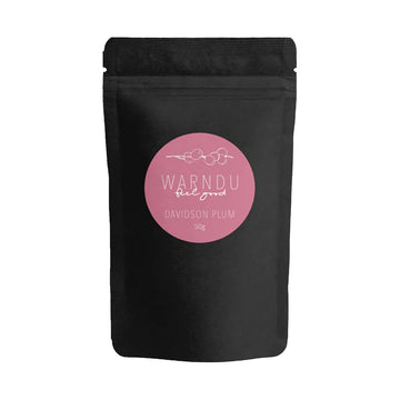 A black packet with a pink round label and the text 'Warndu Feel Good Davidson Plum' on the front.
