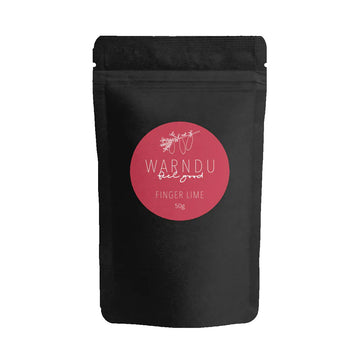 A black packet with a pink round label on the front with the text 'Warndu Feel Good Finger Lime'.