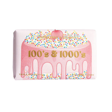 A bar of soap wrapped in packaging illustrated with a cake decorated with 100s and 1000s.