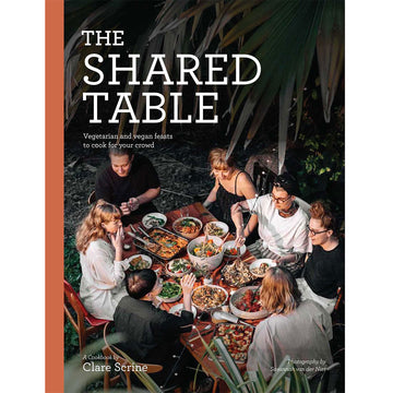 'The Shared Table' book cover featuring a birds eye view of people sitting around a table full of plates of food.