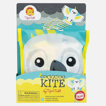 A folded up kite in the shape of a cockatoo inside cardboard packaging.