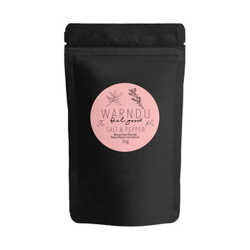 A black packet with a pink round label on the front with the text 'Warndu Feel Good Salt and Pepper'.