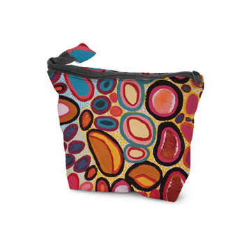 A cosmetic bag with a zip along the top printed with artwork by Dorothy Gabori.