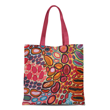 A tote bag with pink handles and printed with artwork by Dorothy Gabori.