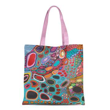 A tote bag with light purple straps and printed with artwork by Amanda Jane and Dorothy Gabori.