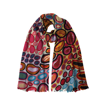 A modal scarf printed with artwork by Dorothy Gabori is wrapped up like its being worn.