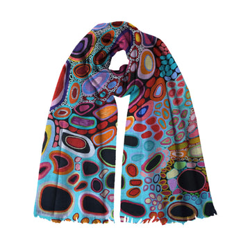A modal scarf printed with artwork by Amanda Jane and Dorothy Gabori is wrapped up like its being worn.