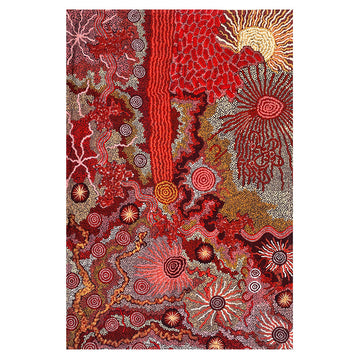A tea towel laying flat and printed with artwork by Damien and Nyinkalya Marks. There are shades of red and brown.