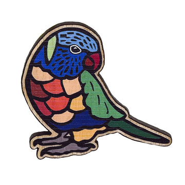 A wooden brooch in the shape of a lorikeet and painted in rainbow colours.