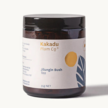 A glass jar with a wide product label that says 'Kakadu Plum Co Jilungin Bush Tea 35g'.