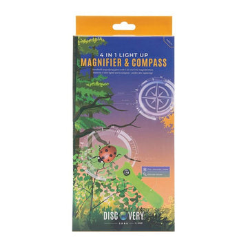 Packaging box of a magnifying glass with the title '4 in 1 Light Up Magnifier & Compass'. There is a photo of a magnifying glass over a ladybug and trees.