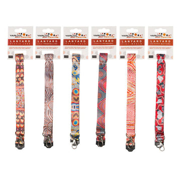 Six lanyards are pictured with a packaging card above each one. They are each printed in different artwork from the Yarliyil Art Centre.