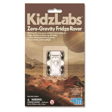 Packaging for the zero gravity fridge rover featuring a small white rover toy covered in plastic in the middle of the card. There is a photo of a planet behind.