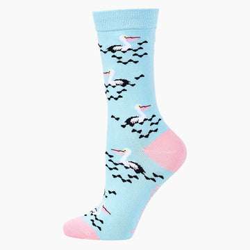 Alternative side view of a light blue sock printed with pelicans swimming with a light pink toe and heel.