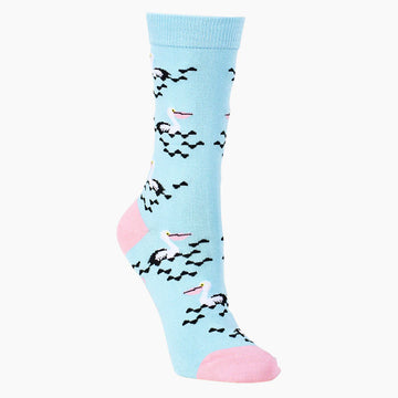Alternative side view of a light blue sock printed with pelicans swimming with a light pink toe and heel.