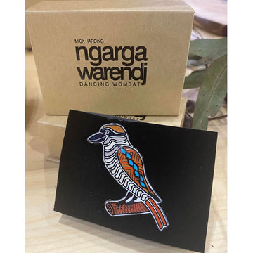 An enamel pin in the shape of a kookaburra.