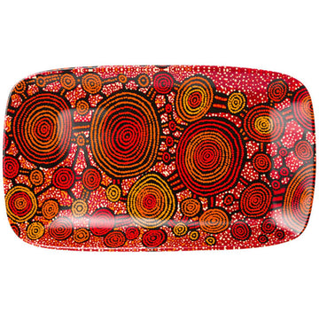 Top down view of a rectangle platter with rounded edges printed with artwork by Teddy Gibson in red and yellow.