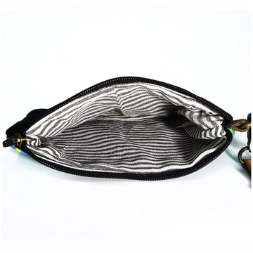 A zippered pouch with a brown wrist strap. The pouch features artwork by Cedric Varcoe in blue and yellow.