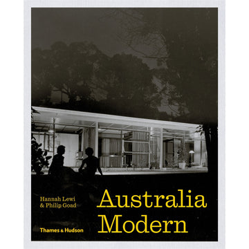 'Australia Modern' book cover featuring a black and white photo of a house in the shape of a rectangle at dark. There are two silhouettes of people in front.