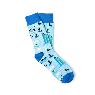A pair of light blue socks with dark blue toes, heels and cuffs. The socks are printed with images of the lake and the Carillon.