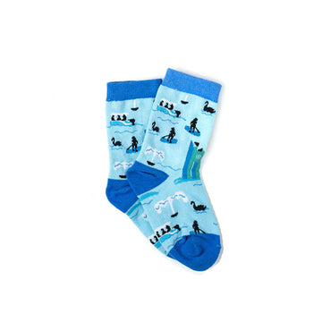 A pair of light blue socks with dark blue toes, heels and cuffs. The socks are printed with images of the lake and Carillon.