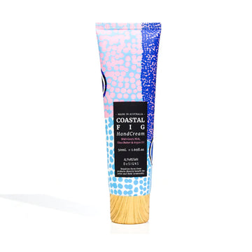 A small tube of hand cream featuring artwork by Lulu Trancollino with a black product label and wood look lid.