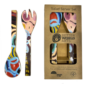 A pair of wooden salad servers printed with multicoloured artwork by Anmanari Brown. One pair is outside and one pair is inside a cardboard box.