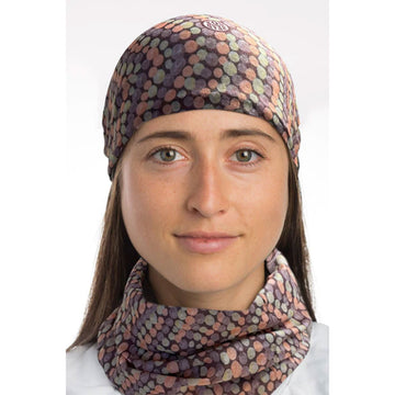 A tubular fabric printed with artwork by Valerie Brumby in orange, green and purple dots forming wavy lines.