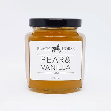 A clear jar with a black lid and white product label on the front. The label says 'Black Horse Pear and Vanilla jam with an image of a horse at the top. The jam can be seen through the glass.
