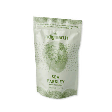 A light green packet with darker green overlays. There is a line drawing of parsley in the middle and the text 'Indigiearth Sea Parsley' written in green.