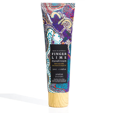 A tube of hand cream featuring artwork by Elaine Warnatjura Lane with a black product label and wood look lid.