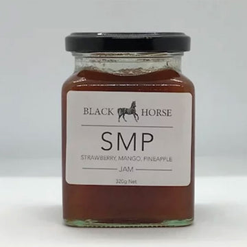 A clear jar with a black lid and white product label. The label says 'Black Horse SMP Strawberry Mango Pineapple Jam' with an image of a horse at the top. The jam can be seen through the clear jar.