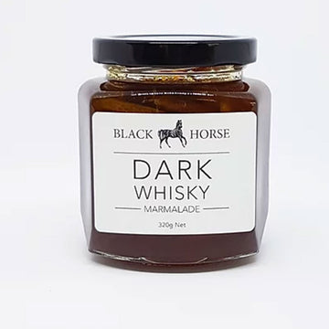 A clear jar with a black lid and white product label. The label says 'Black Horse Dark Whisky Marmalade' with an image of a horse. The marmalade can be seen through the clear jar.