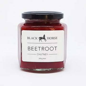 A clear jar with a black lid and white product label. The label says 'Black Horse Beetroot Chutney' with an image of a horse at the top. The chutney can be seen through the jar.